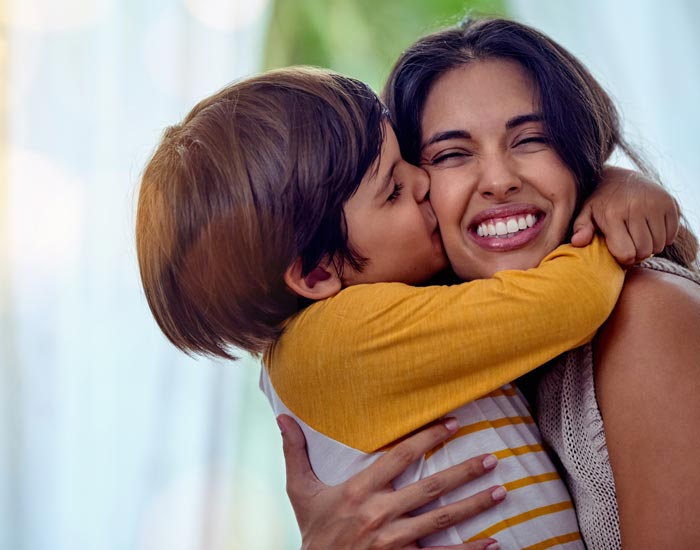 child kissing mother's cheek